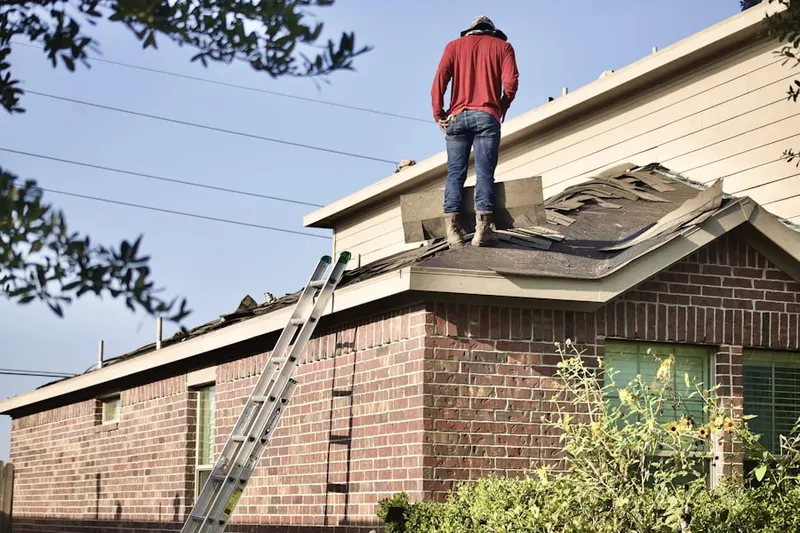 Professional roofer working on a residential roof in Anden at the Woods